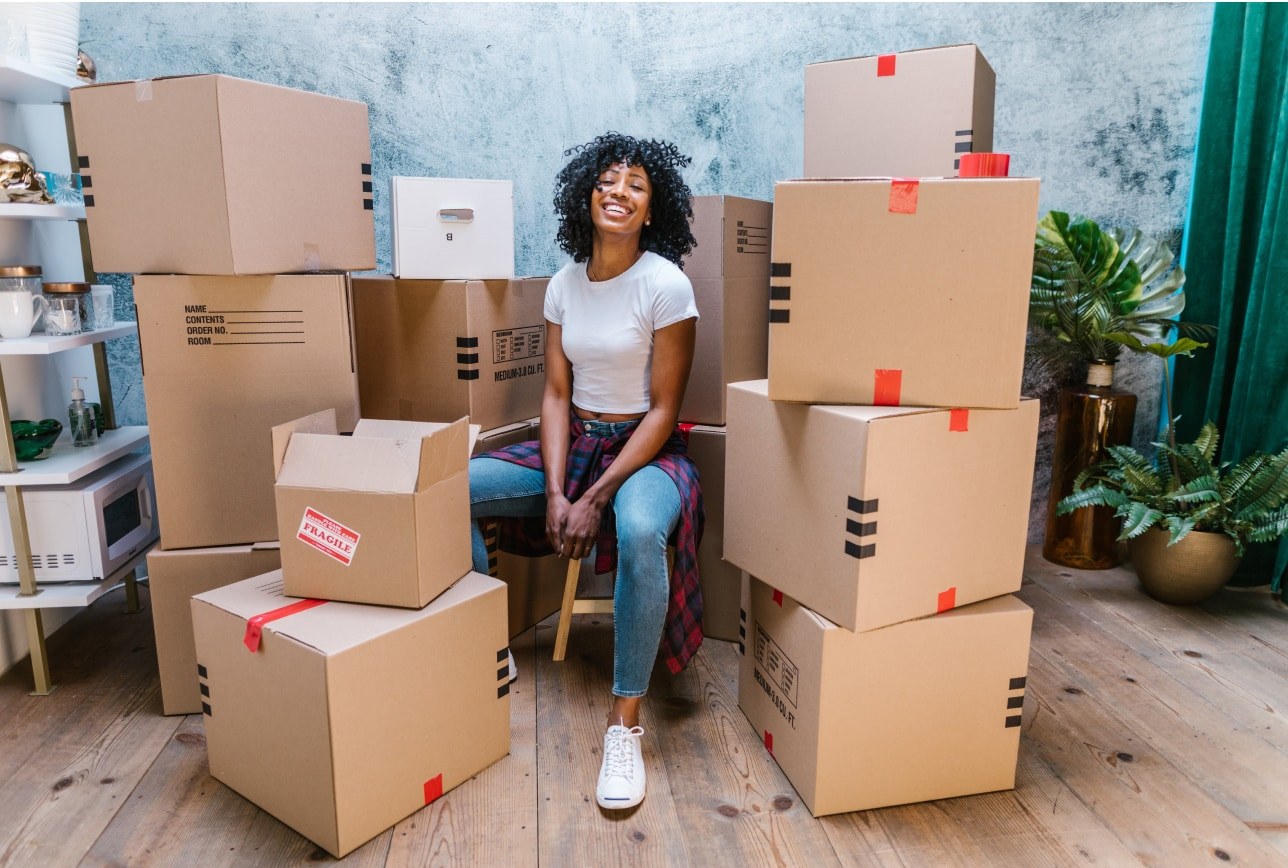 Woman surrounded by moving boxes