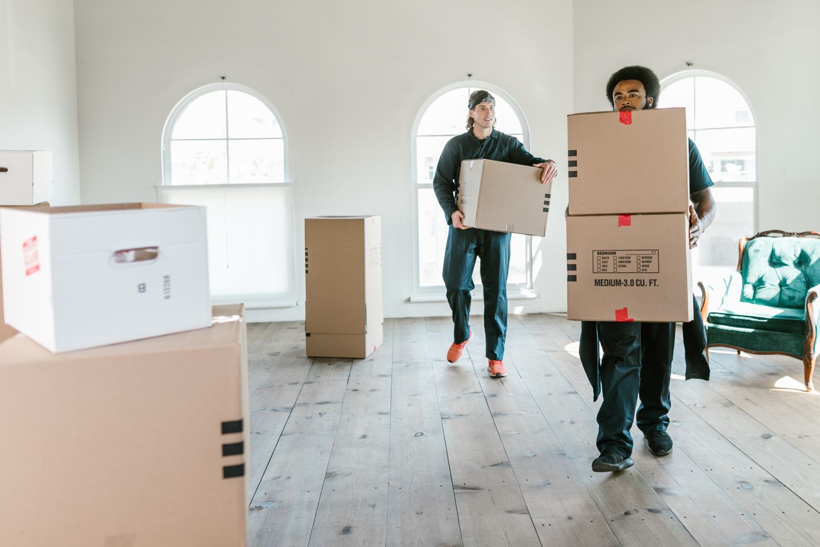 Two movers carrying boxes