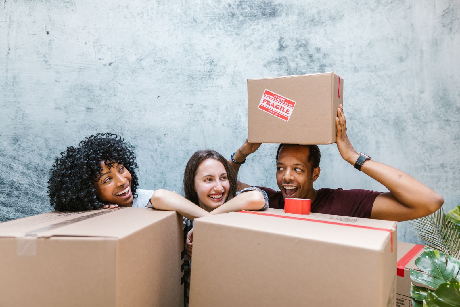 Friends packing moving boxes